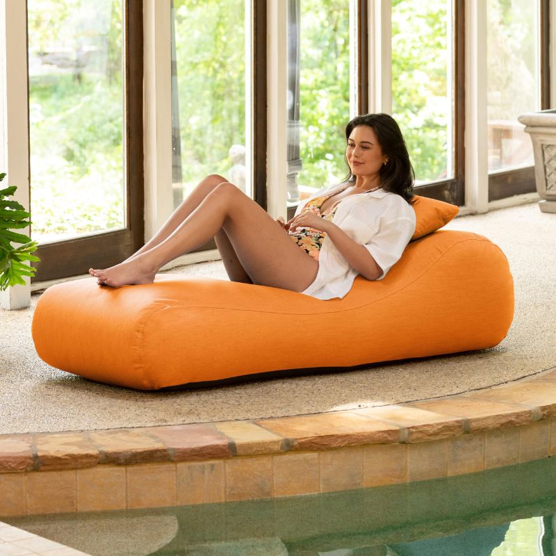Jaxx Arlo outdoor bean bag lounger in Tangerine Sunbrella fabric styled poolside for vibrant outdoor relaxation