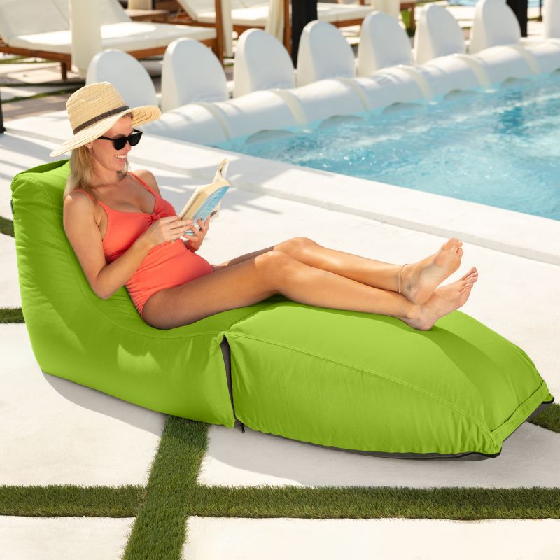 Woman reading poolside on the Prado outdoor bean bag lounger in Lime Green
