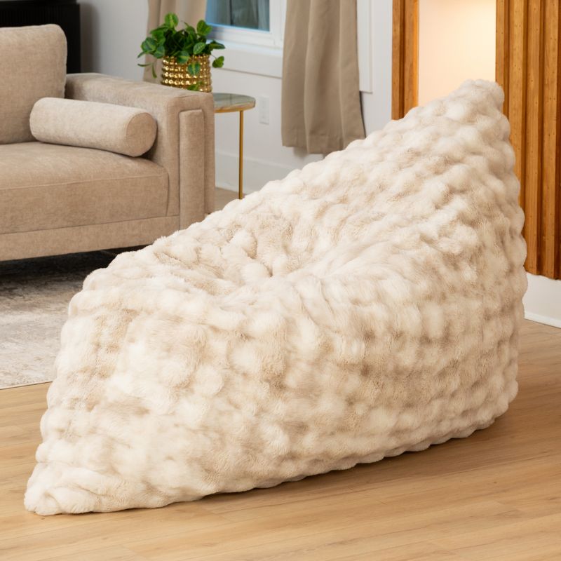The oversized Raven-Symoné LoungePuff faux fur lounger propped upright in Phantom Cream