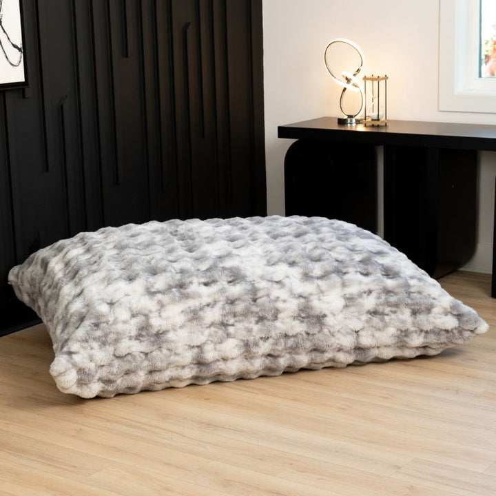 The oversized Raven-Symoné LoungePuff faux fur floor lounger laid flat in Phantom Grey