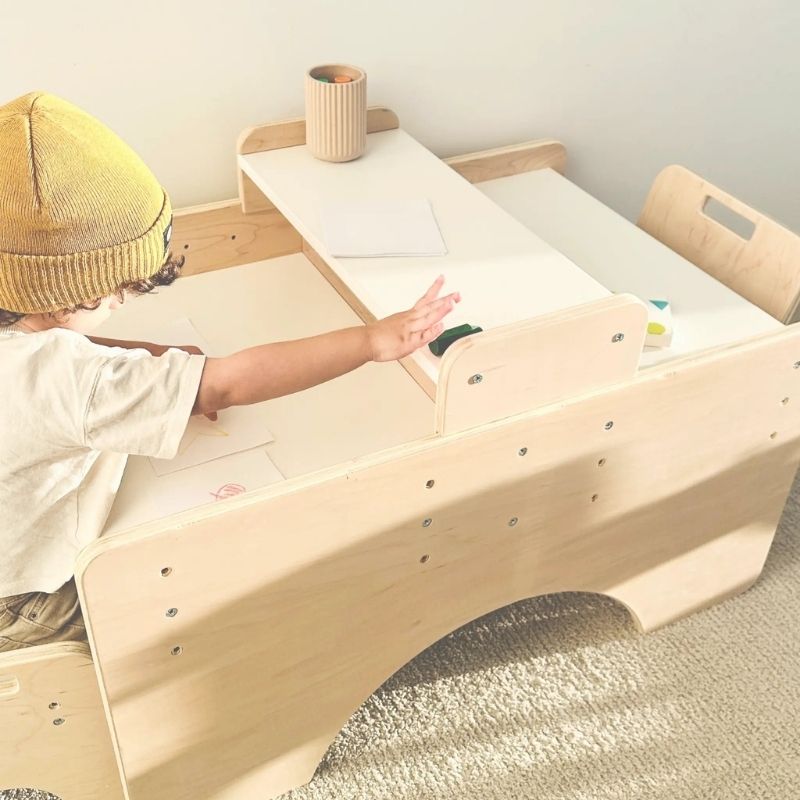 Child actively working at the Sapiens Child Papaya Double Montessori Table, showing the independently adjustable child-height table and chair supporting focused independent learning and activity