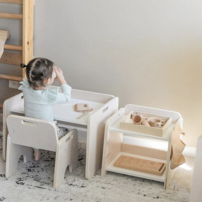 Child actively accessing items from the Sapiens Child Papaya Montessori Mini Shelf, showing the child-height design that supports independent reach for cups, jugs, and Montessori materials