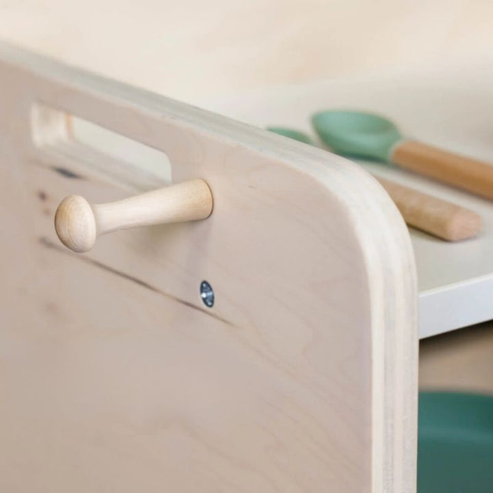 Sapiens Child Papaya Montessori Mini Shelf close-up view showing the removable hook detail for hanging bibs, cloths, or small accessories alongside the child-height shelf surface