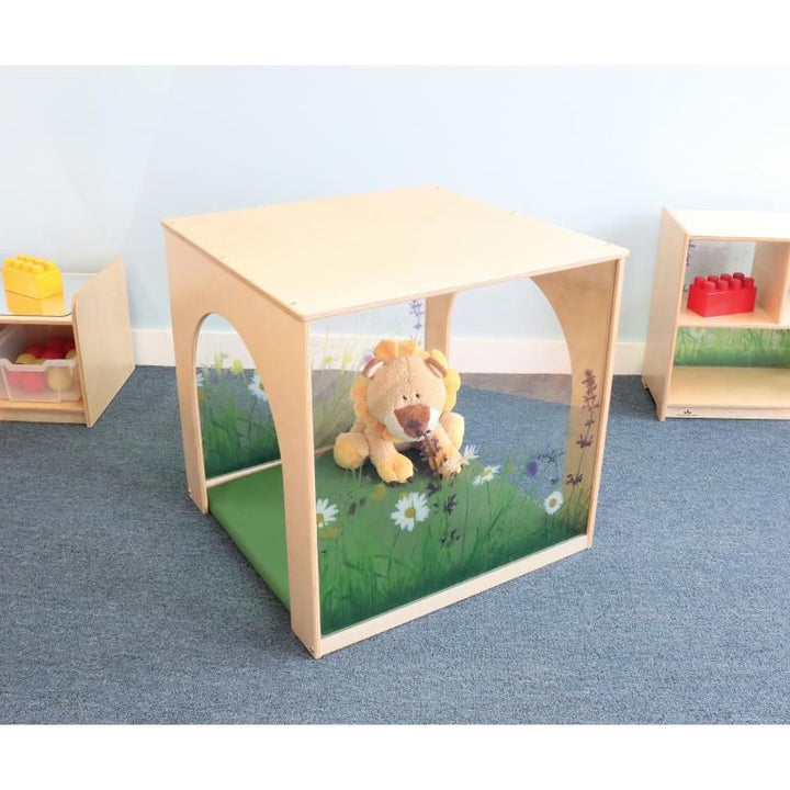 Whitney Brothers Nature View Playhouse Cube with Mat set up as a calm corner in an early learning classroom, with a plush toy resting on the green mat
