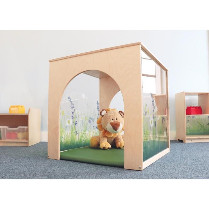 Arched tunnel opening on the Whitney Brothers Nature View Playhouse Cube with Mat, showing a cozy reading nook with a fitted green floor mat