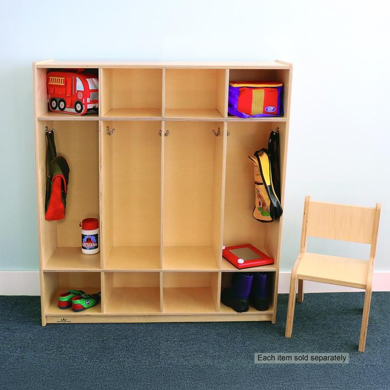 Whitney Brothers Four Section Coat Locker in a preschool classroom, a birch plywood preschool coat locker holding backpacks, lunch bags and boots in its coat cubbies
