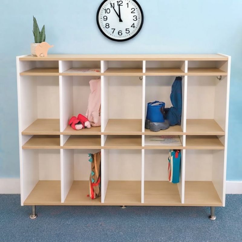 Whitney Brothers elevatED 10 Section Coat Locker in a bright classroom, a preschool coat locker holding children's boots, mittens and backpacks in individual cubbies with hooks