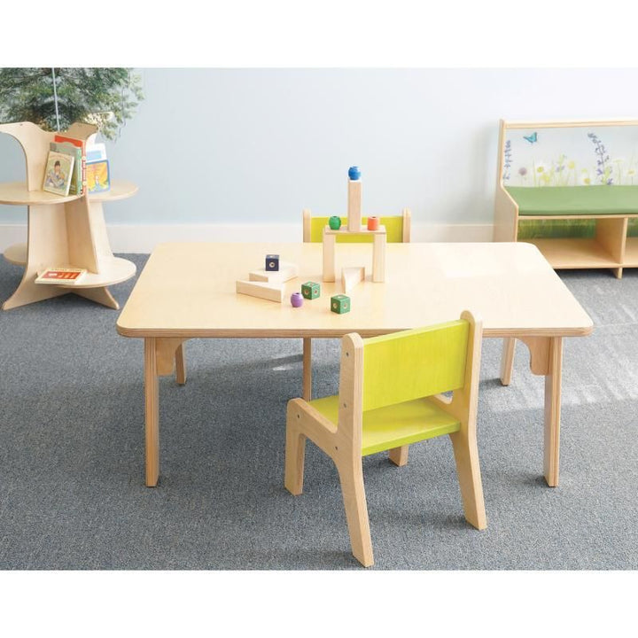 Whitney Plus Rectangle Table by Whitney Brothers at 18 inches, a preschool rectangle table with wooden blocks and lime green chairs in a bright classroom