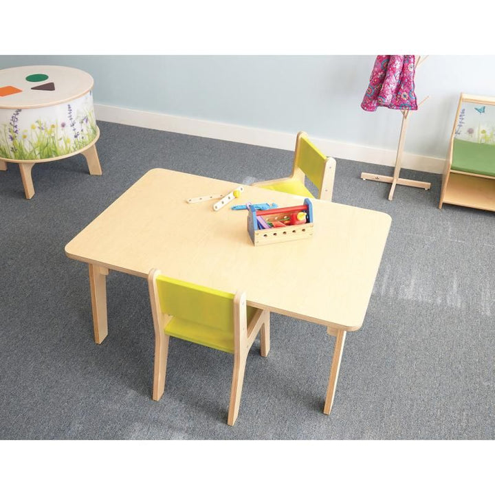 Overhead view of the 20 inch Whitney Plus Rectangle Table from Whitney Brothers, a preschool rectangle table with a toy toolbox and two classroom chairs