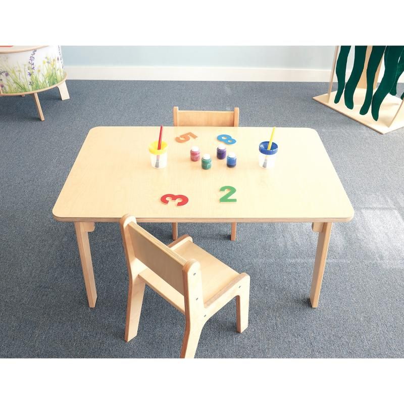 Overhead view of the 22 inch Whitney Plus Rectangle Table from Whitney Brothers, a classroom activity table set with paint pots and number shapes