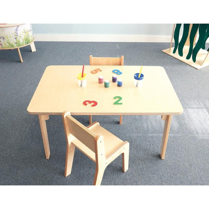 Overhead view of the 22 inch Whitney Plus Rectangle Table from Whitney Brothers, a classroom activity table set with paint pots and number shapes