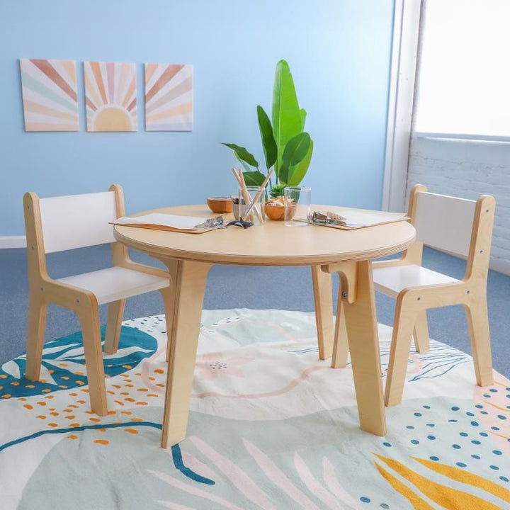 Whitney Brothers Whitney Plus Round Table at 22 inches high set with clipboards, pencils and nature collections, a round classroom table for hands-on learning