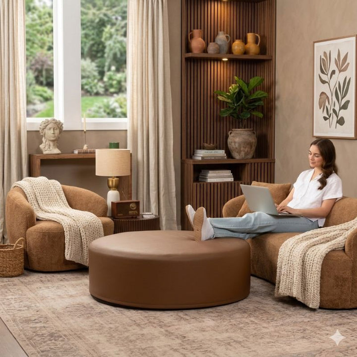 Jaxx Candler round ottoman in warm brown, used as a coffee table alternative in a styled living room