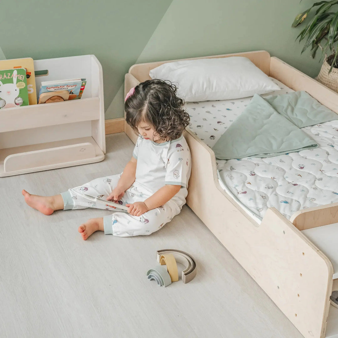 Sapiens Child Apple Montessori floor bed with rails in Birch plywood finish, showing the natural wood grain and rounded safety edges of the Vancouver-made toddler floor bed