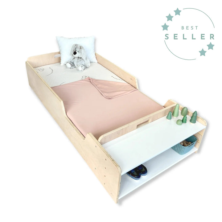 Sapiens Child Apple Montessori floor bed with rails in a children's bedroom setting, showing the protective border rails and open-entry design for toddler independence