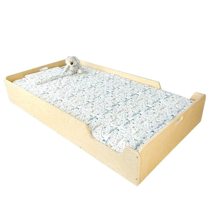 Second landscape view of the Sapiens Child Apple Montessori floor bed with rails in Maple, showing the adjustable side shelf and compact proportions for toddler bedrooms