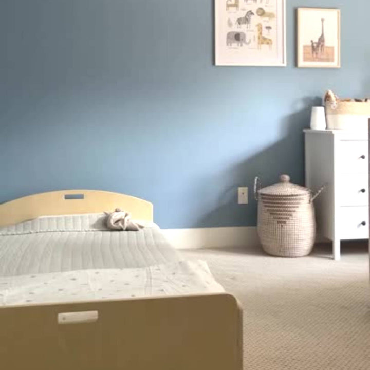 Indoor UGC view of the Sapiens Child Cherry Montessori floor bed shelf-free variant showing real-home placement in a compact bedroom setting