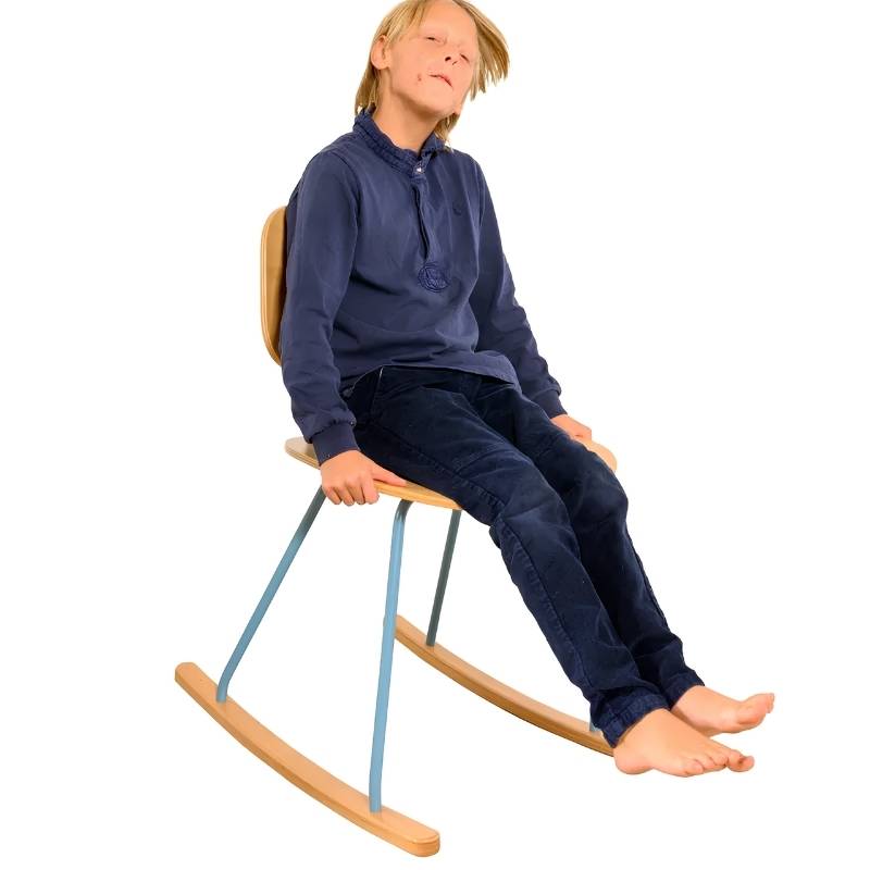 Child relaxing in the TFH Mindflow Rocking Chair, a sensory rocking chair offering vestibular input for focus and calm