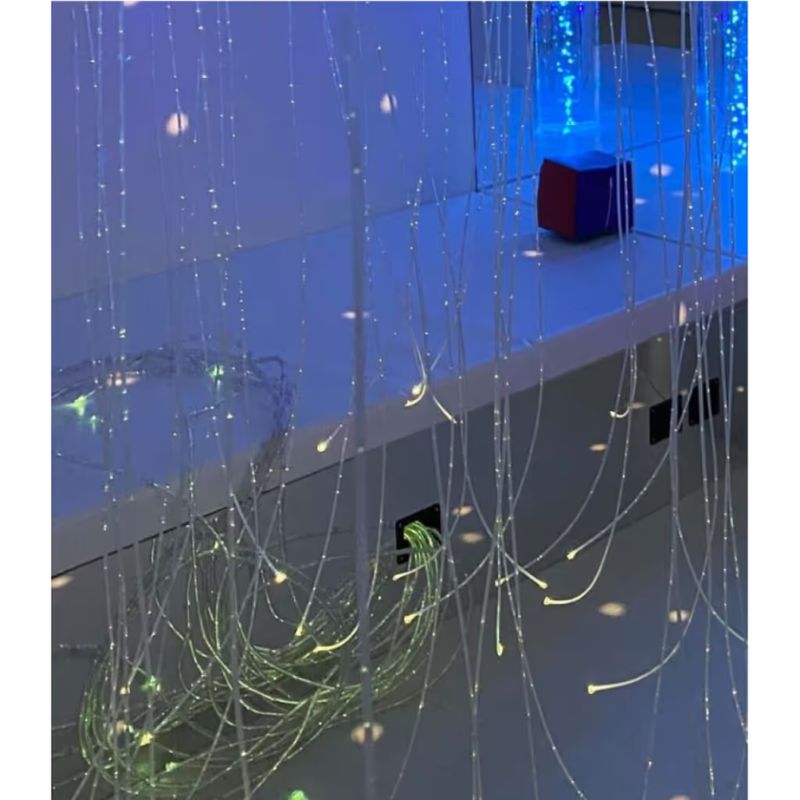 TFH Square Podium Bench mirrored edge reflecting blue fibre optic lighting and a bubble tube in a sensory room