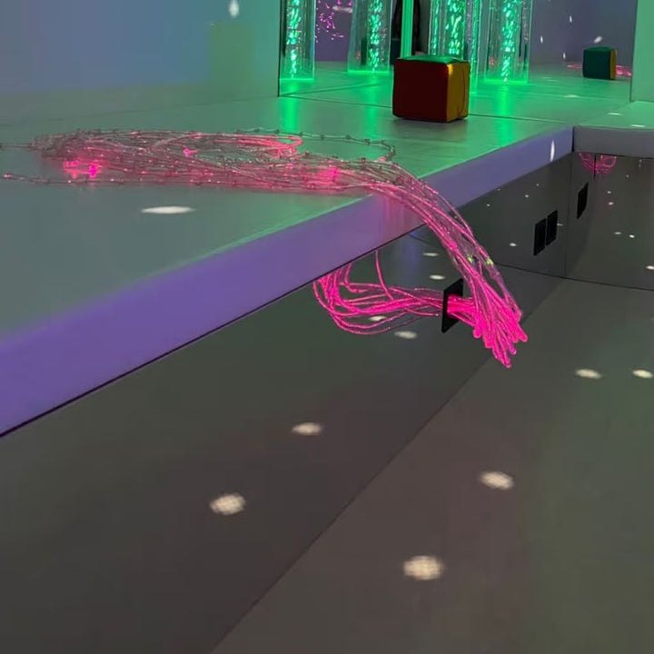TFH Square Podium Bench mirrored edge with a connected fibre optic port beside a bubble tube in a sensory room