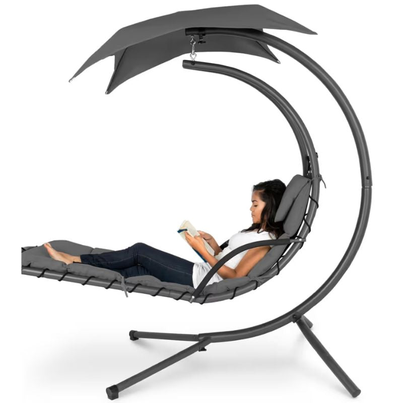 TFH Leaf Chair cocoon sensory swing chair with a woman reading inside its canopy, showing gentle vestibular sway in use at home