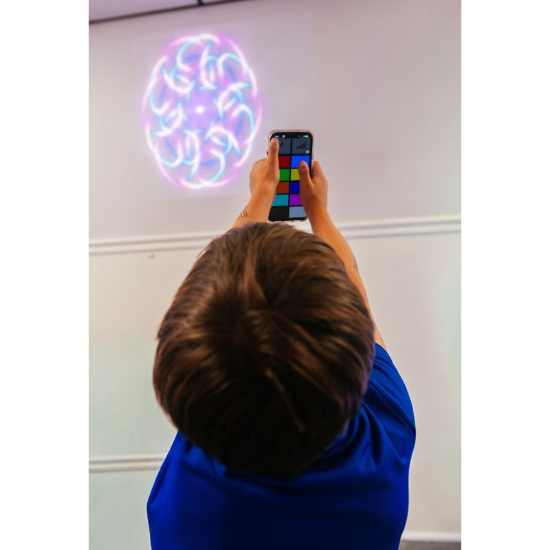 TFH ChromaTheme abstract pattern video projected on a wall while a student adjusts themes using the app