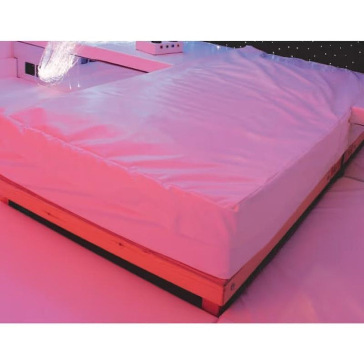 Close-up of the TFH Waterbed with Platform showing the wooden frame and white vinyl cover of this sensory waterbed