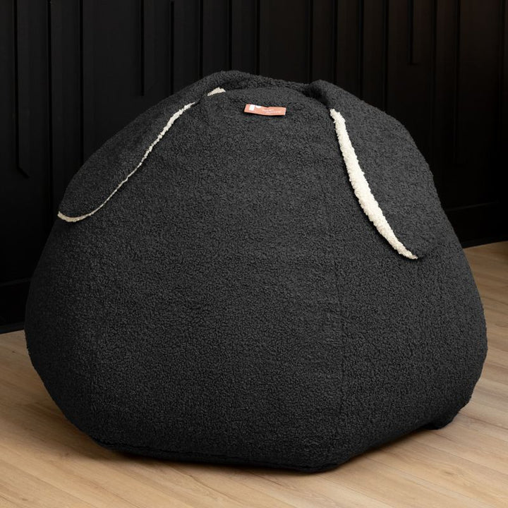 Raven-Symoné HopSeat sherpa bean bag chair in black, a low-angle view showing the bunny-ear detail and deep-pressure comfort