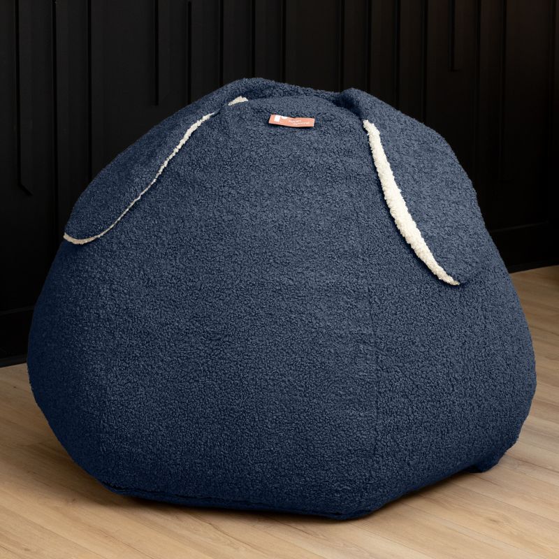 Raven-Symoné HopSeat sherpa bean bag chair in blue, a low-angle view showing the bunny-ear detail and deep-pressure comfort