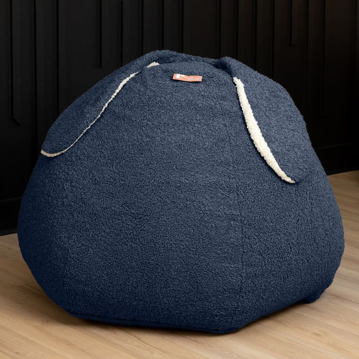 Raven-Symoné HopSeat sherpa bean bag chair in blue, a low-angle view showing the bunny-ear detail and deep-pressure comfort