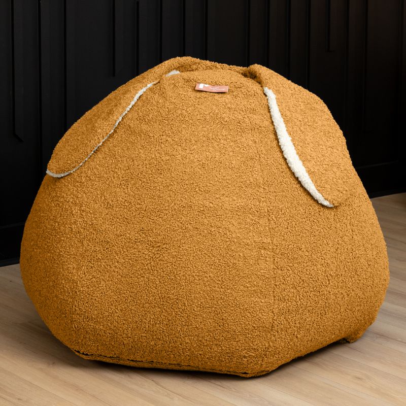Raven-Symoné HopSeat sherpa bean bag chair in gold, a low-angle view showing the bunny-ear detail and deep-pressure comfort
