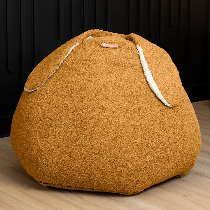 Raven-Symoné HopSeat sherpa bean bag chair in gold, a low-angle view showing the bunny-ear detail and deep-pressure comfort