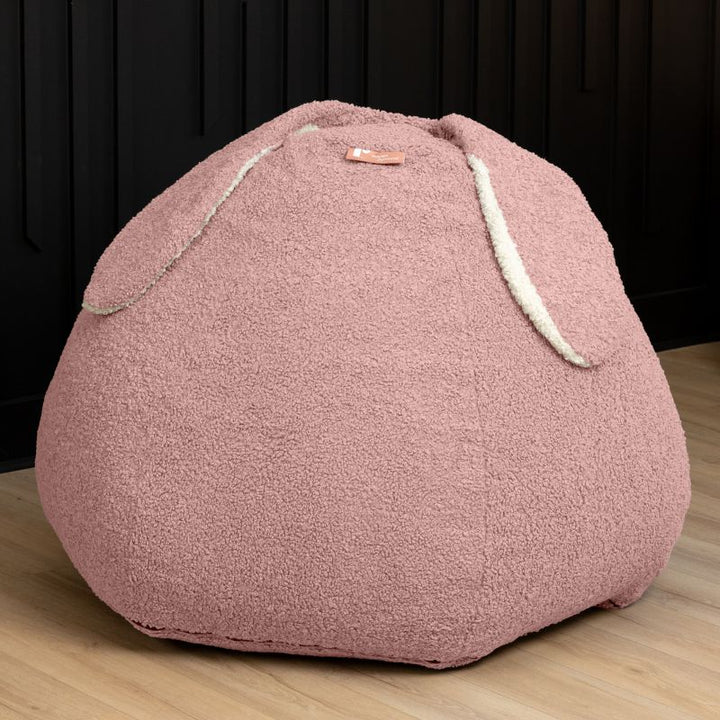 Raven-Symoné HopSeat sherpa bean bag chair in pink, a low-angle view showing the bunny-ear detail and deep-pressure comfort