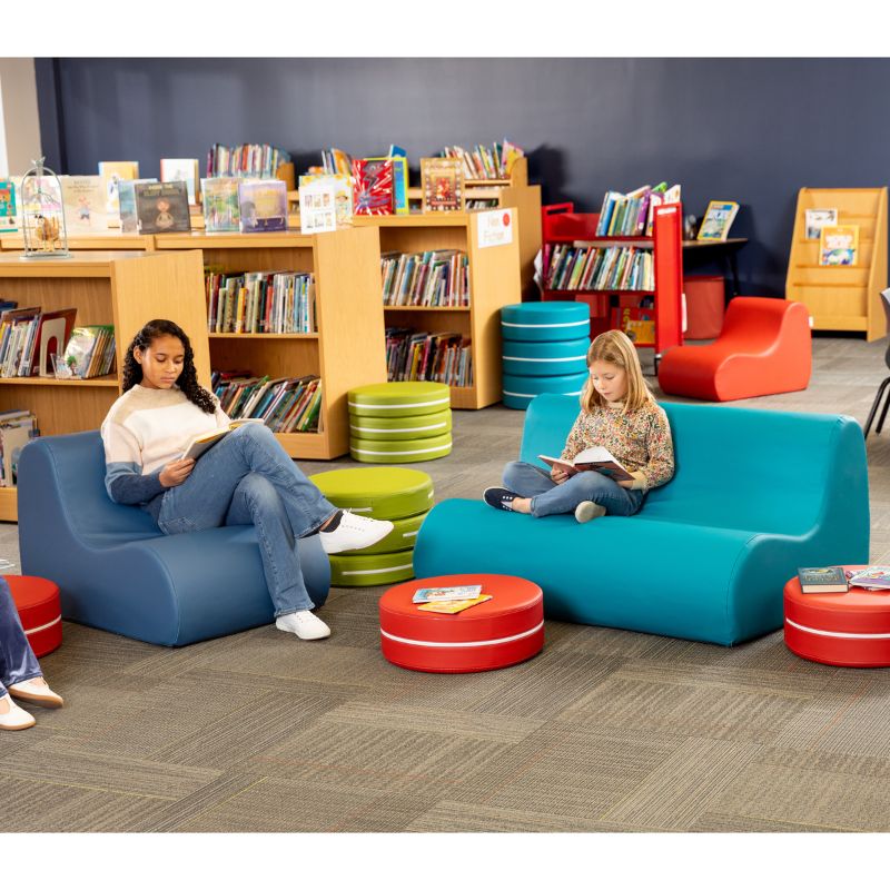 Blue and teal Jaxx Midtown soft seating couches with ottomans in a school library calm corner setting
