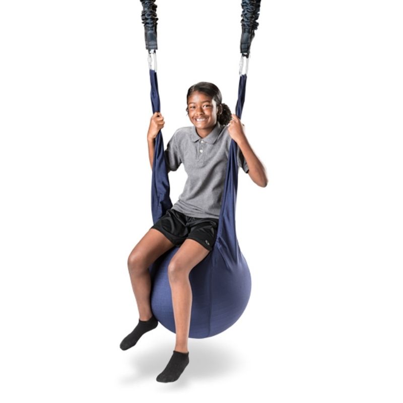 A child riding the Southpaw Moon Ball Swing, a vestibular and proprioceptive therapy swing for sensory rooms and home use