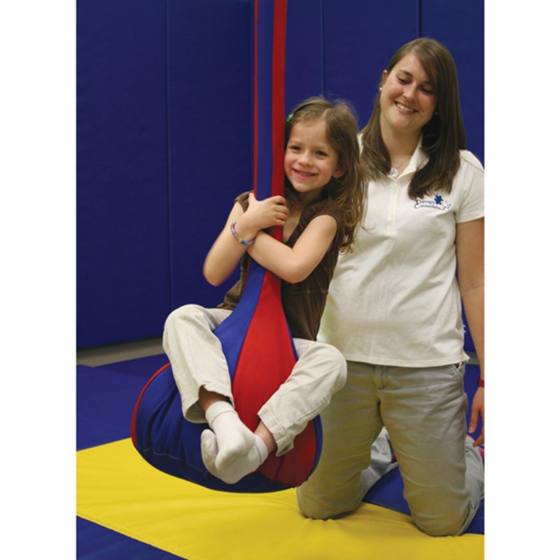 Child riding the Southpaw Moon Swing, a vestibular therapy swing for sensory integration and balance development