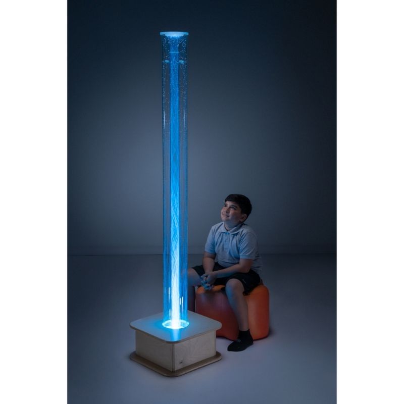 Southpaw MSE+ Interactive Popcorn Tube 72" with a child seated in front of the waterless sensory column in a therapy room setting