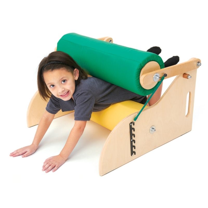 Child actively playing with the Southpaw Advantage Line Sensory Steamroller, crawling through the foam rollers for deep pressure and proprioceptive input