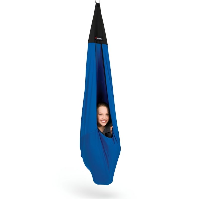 Child playing actively inside the Southpaw Snuggle Swing, demonstrating vestibular input and deep pressure sensory engagement during indoor therapy play