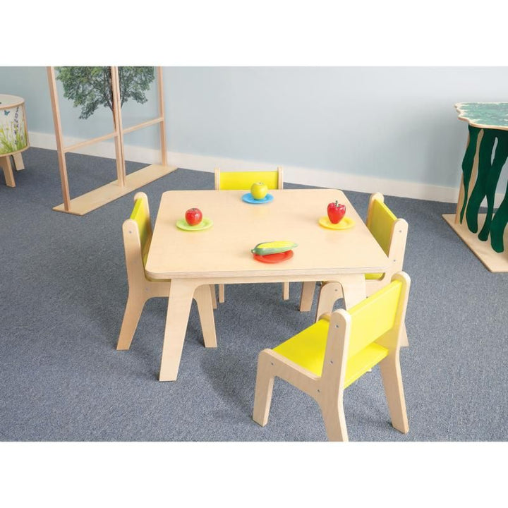 Whitney Brothers Whitney Plus Square Activity Table 20H set up as a daycare table for four children with yellow chairs and pretend play food