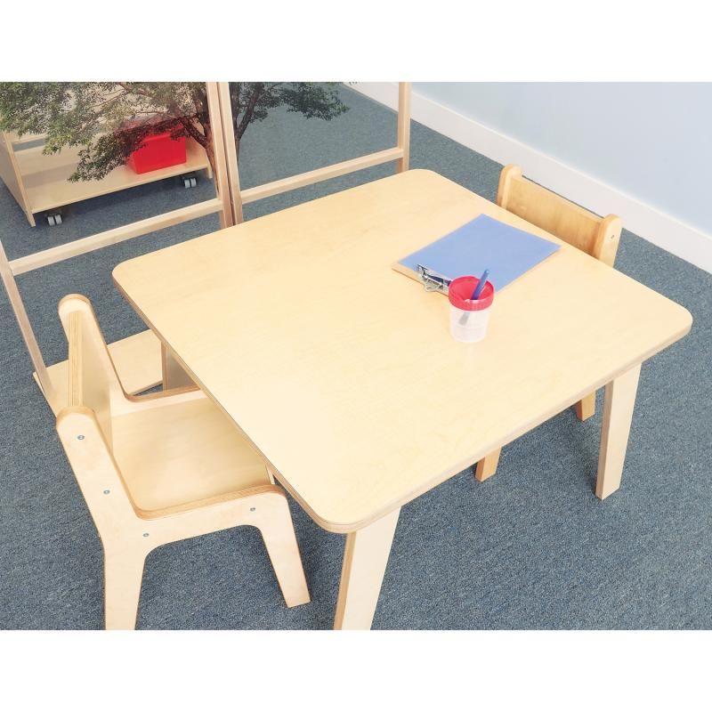 Overhead view of the Whitney Brothers Whitney Plus Square Activity Table 22H with two birch chairs, a clipboard and a pencil cup for learning activities
