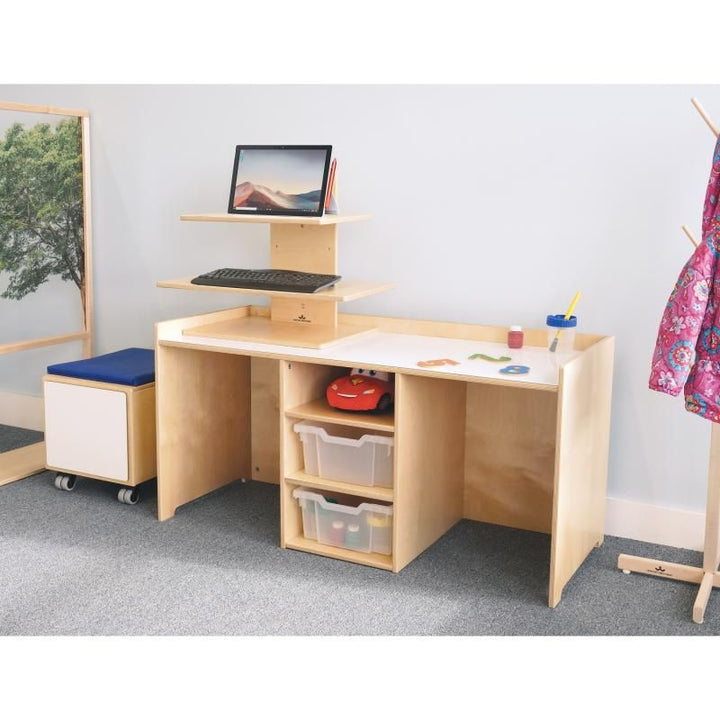 Whitney Brothers STEM Activity Desk with Trays set up as a makerspace table with a tiered computer riser and a rolling storage seat, preschool STEM furniture in birch plywood