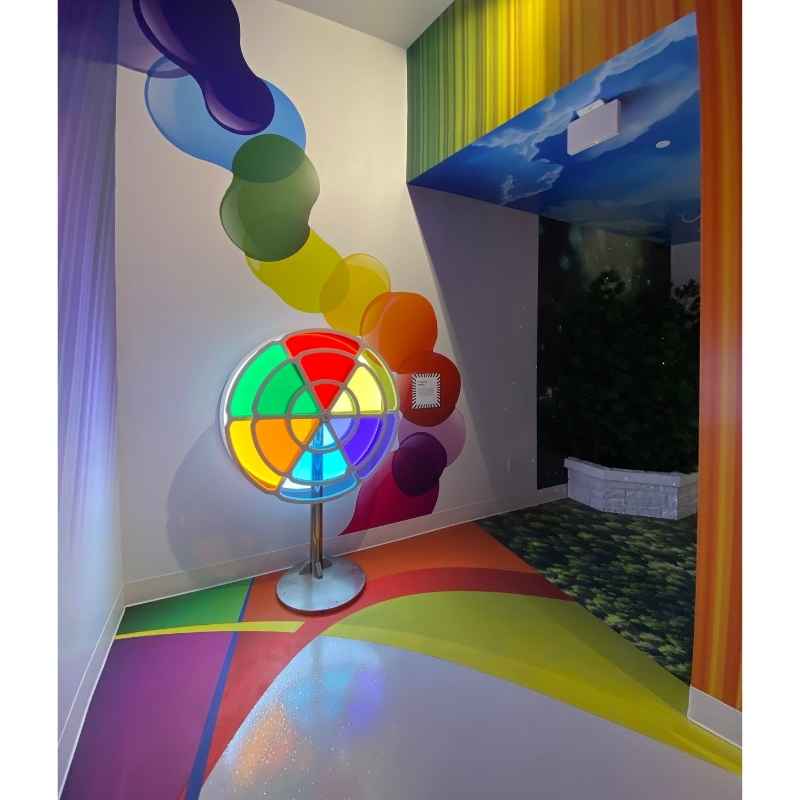 LiteZilla ChromaWheel installed as an interactive color wheel feature in a fully immersive sensory room with painted murals and lighting