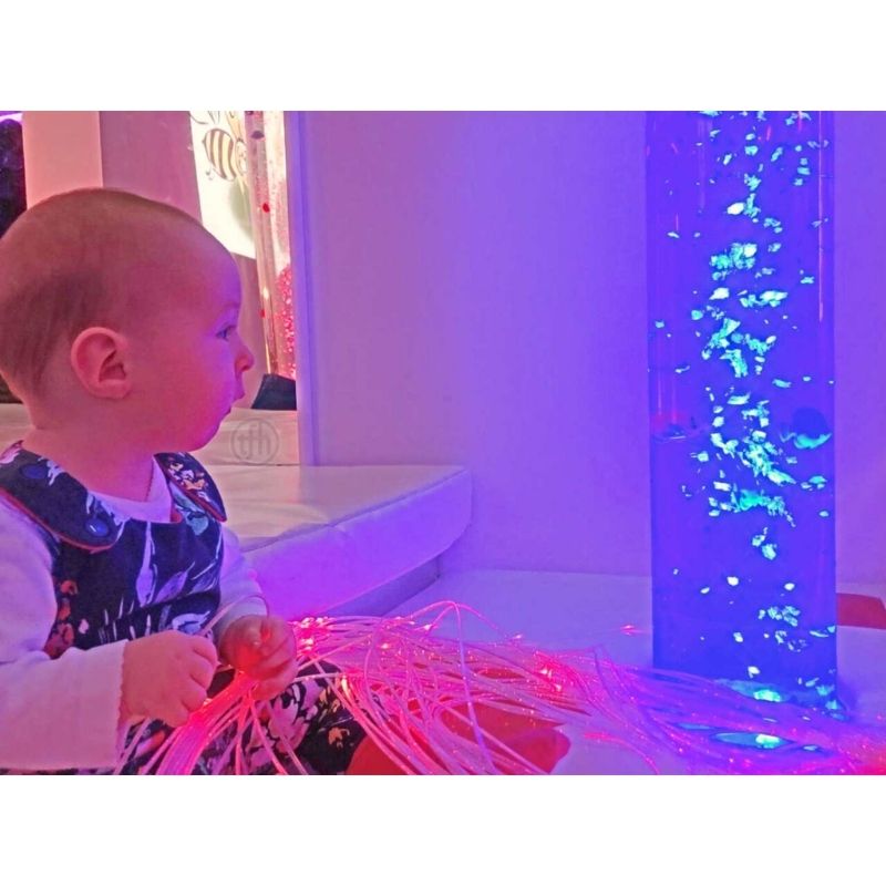 Baby engaging with TFH Aquarium Bubble Tube 6" demonstrating the sensory bubble column's visual stimulation for infants and young children in home sensory spaces