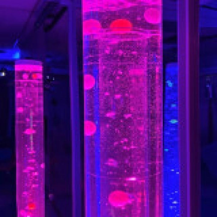 TFH Giant Bubble Tube Cascading Balls and Beads Insert lit in pink and blue, a sensory accessory for therapy rooms and sensory spaces