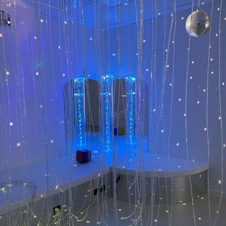 TFH Bubble Tube Corner Seat Base with fibre optic tails routing through the podium base alongside bubble tube in blue light