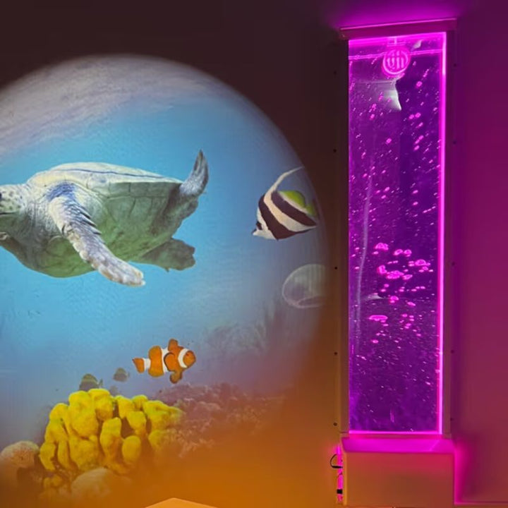 A TFH Bubble Wall lit in purple beside an underwater projector display in a multi-sensory room