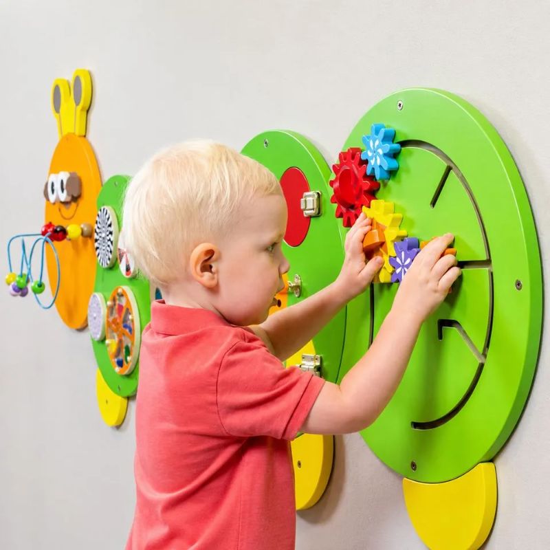 TFH Caterpillar Activity Wall Panel section showing interlocking cogs and lockable doors with textured surfaces for tactile discrimination and fine motor sensory play