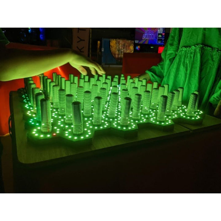 TFH Electro Wobble Garden Activity Panel with green LED display active showing the touch-responsive light pattern across the 72 spring-sensor surface