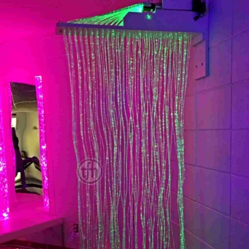 TFH Wall Mounted Fiber Optic Curtain glowing in green, demonstrating the colour-changing fiber optic sensory light effect in a therapy room setting